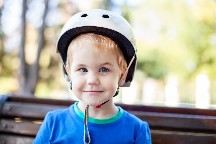child with eye turn wearing bicycle helmet